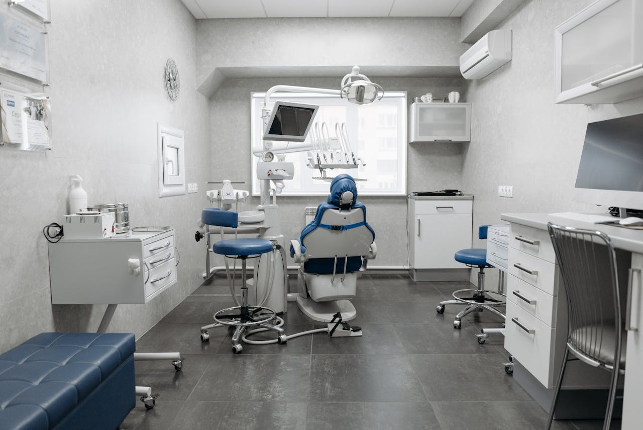 Spacious dental clinic with modern equipment and clean, white design.